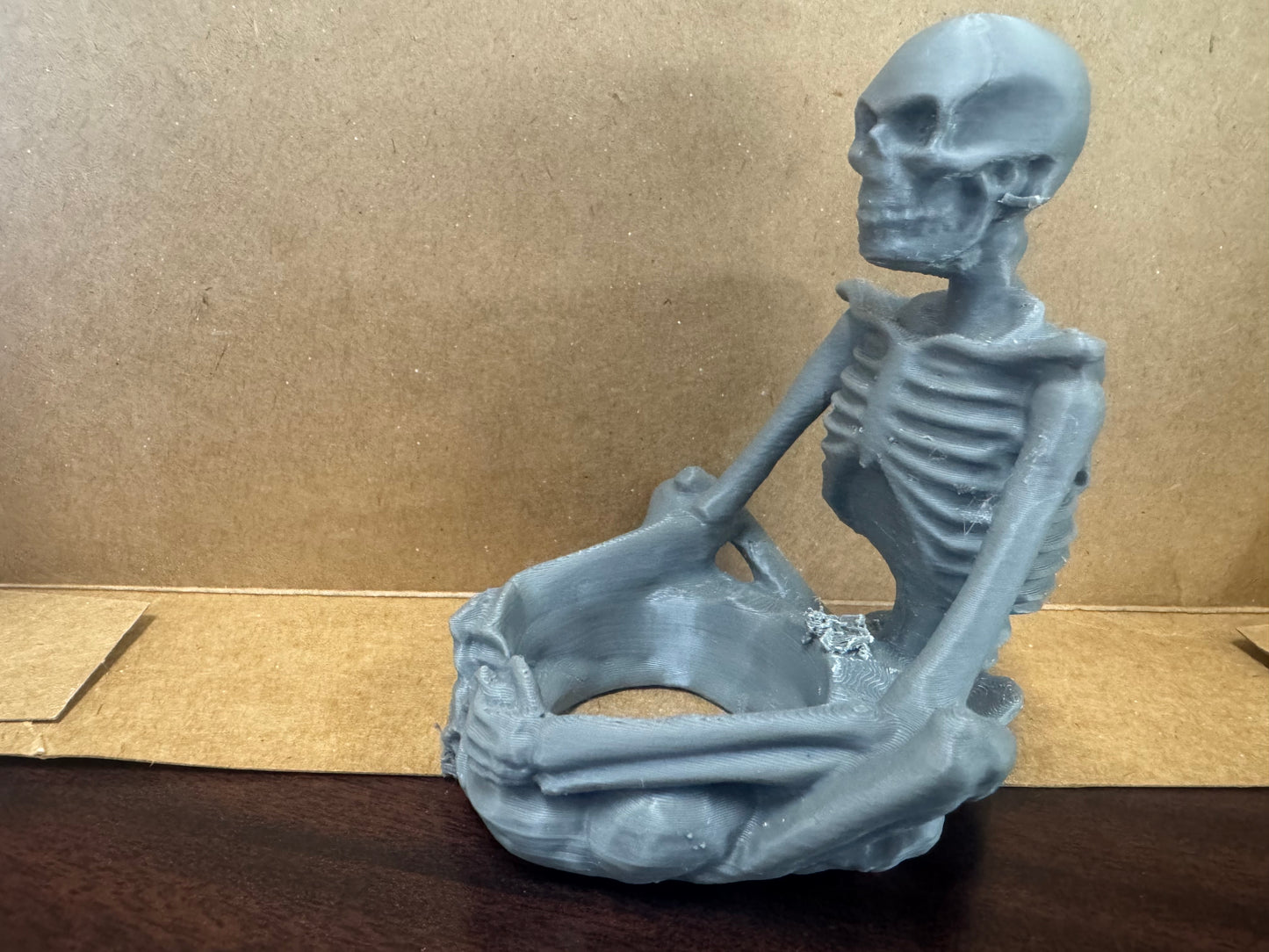 Sitting skeleton candle holder