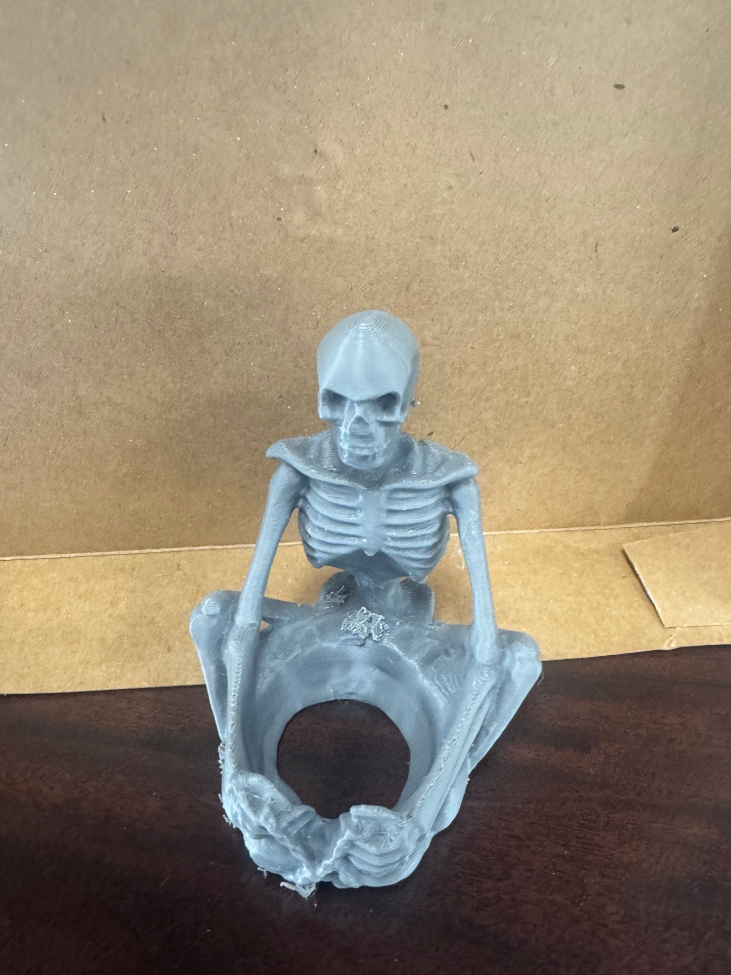 Sitting skeleton candle holder